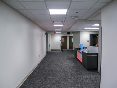 Ernie Pyle Hall’s renovated second-floor reception area in a hallway with a desk.