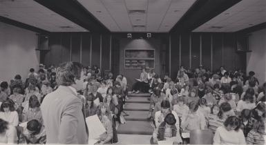 A black and white photo of students in the old Ernie Pyle Hall auditorium.