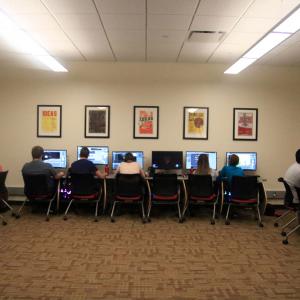 Students work at a row of computers