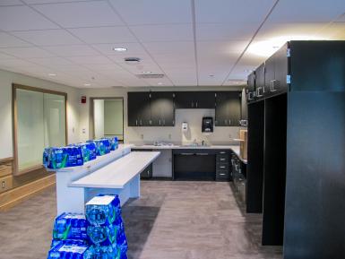 Ernie Pyle Hall’s renovated lounge area, with kitchen amenities and many cases of bottled water