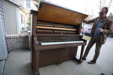 Jon Vickers, director of the IU Cinema, stands next to the 1916 Henderson Piano that will be burned in Dunn Meadow on Feb. 7