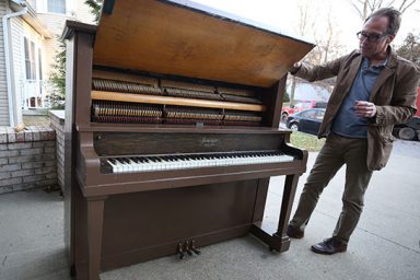 Jon Vickers, director of the IU Cinema, stands next to the 1916 Henderson Piano that will be burned in Dunn Meadow on Feb. 7