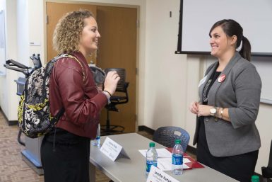 Junior public relations student Peyton Miller networks with Jennifer Hurtubise, BAJ'06, vice president of communications at the Indiana Hospital Association at the end of Career Day Friday.