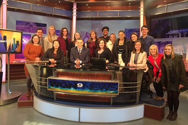 WGN morning show hosts Larry Potash, Robin Baumgarten and Paul Konrad in a group photo with Media School students during their trip to Chicago
