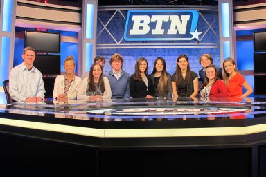 Students pose at the Big Ten anchor desk.