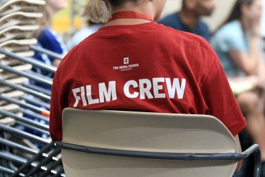 A student wears a shirt with "Film Crew" on the back