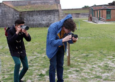 Aaron Ye and Ethan Gill take photographs at Fort Pickens during the 2017 Gulf Islands National Seashore alternative spring break trip.