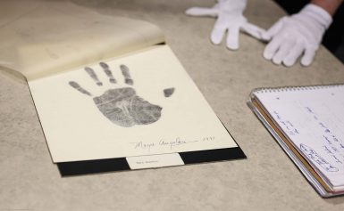 Maya Angelou's handprint and signature on white paper.