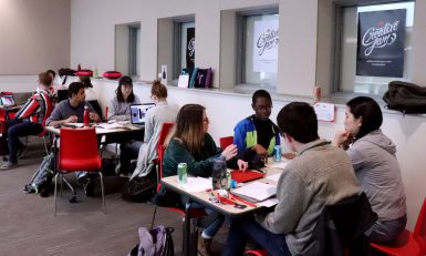 Students work in groups during the Adobe Creative Jam Tournament