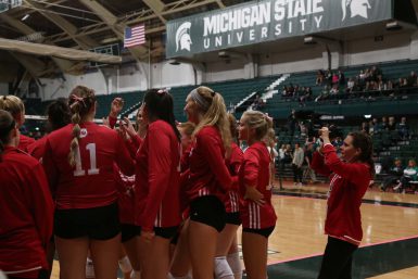 Master's student Morgan Gard films a huddle during a match at Michigan State University.