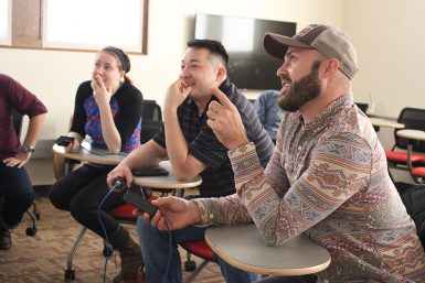 INPA judges Jessica Phelps, Corey Perrine and Dustin Alton Strupp analyze student work. (Kristen Braselton | The Media School)