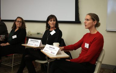 Jamie Luke speaks and Michele DeSelms and Katie Mettler look on.