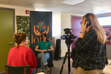 Students Emma Hamilton (left) and Karli VanCleave interview Lotus volunteer and Media School alumna Grace Waltz, BA’16, for a volunteer tribute video as part of The Media School’s Stories of Peace service project.