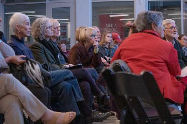 An audience listens to James Neff in the Franklin Hall commons.