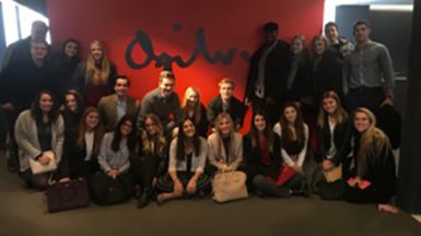 Bloomington Ad Club members pose in front of the Ogilvy logo