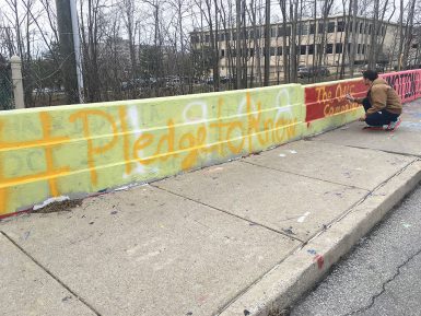 Garrett Stanley of Team Cream painted a bridge to bring awareness to his team's campaign event. Two IU teams have entered their campaigns in the national Bateman competition. (Bailey Briscoe | The Media School) 