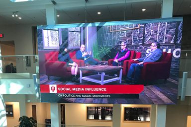 An audience watches as journalism senior Erica Gibson (left to right), assistant professor Jason Peifer, political scholar and Patten lecturer Kathleen Hall Jamieson and assistant professor Gerry Lanosga discuss social media’s influence on politics in a live streamed panel discussion from the Ken and Audrey Beckley Studio.