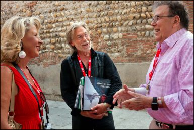 Emeritus professor Steve Raymer (right), talks with Emmanuel Sautai of Beaune, France, and his wife at the Visa Pour l’Image international photojournalism festival