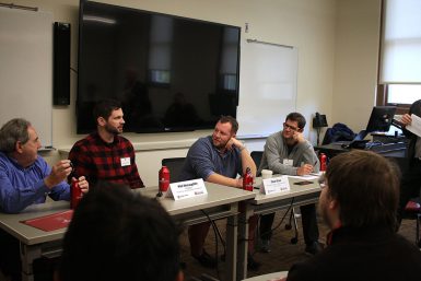 Phil McLaughlin speaking on a panel to a classroom of students