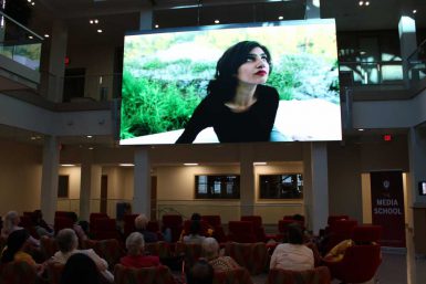 An audience in the Franklin Hall commons watches one of the films produced by Punjabi students. (Courtesy photo)