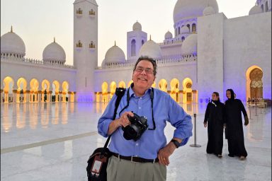 Professor emeritus Steve Raymer poses at the Sheikh Zayed Grand Mosque in Abu Dhabi.