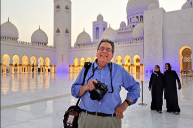 Professor emeritus Steve Raymer poses at the Sheikh Zayed Grand Mosque in Abu Dhabi.