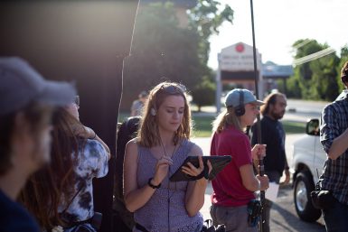 Senior Mia Siffin, one of three Media School students working as paid crew members on The MisEducation of Bindu, script supervises during filming.
