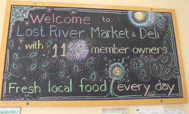 A sign reading "Welcome to List River Market & Deli with 1139 member-owners. Fresh local food every day.