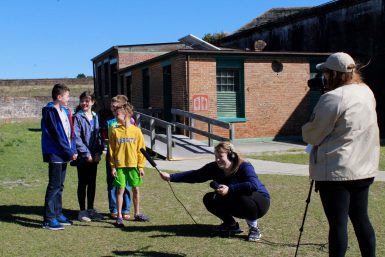 Students Anna Howell and Sydney Ziegler interview park visitors during the 2018 Gulf Islands National Seashore alternative spring break trip.