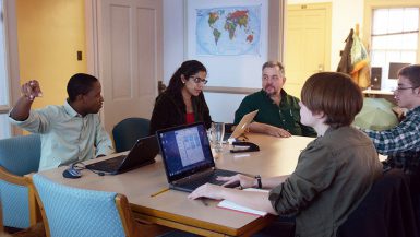 Professor of practice Mike Sellers and SPEA assistant professor Shahzeen Attari work with students to create game.