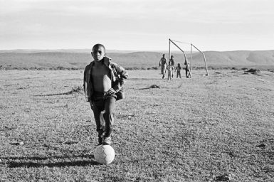 This young soccer player is a descendant of warrior chiefs who led the 100-year Xhosa resistance against Afrikaner and British settlers in South Africa. (Photo by Cedric Nunn.)