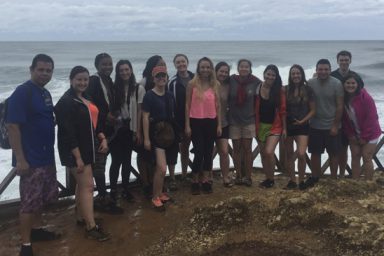 Students pose by the ocean in Costa Rica