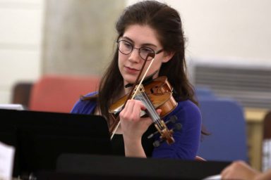 A woman playing a violin