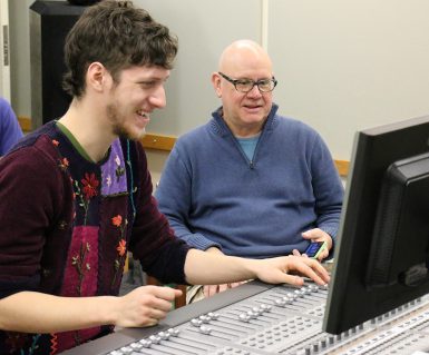 Jacobs senior Kevin Weinberg, left, a recording arts major, worked with Mark Hood of the Jacobs recording arts program in the control booth during the Double exposure recording sessions. Student composers, performers and filmmakers will have recordings for their portfoilios. (Sam Robinson, junior | The Media School)