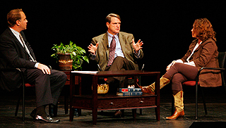 Former Washington Post executive editor Leonard Downie speaking to a man and a woman