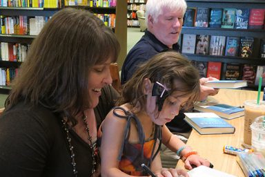Juniper French signing books with Kelley and Tom French