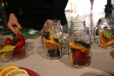 Mason jars with oranges, berries and kiwi