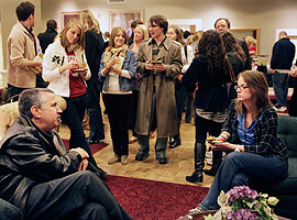 Friedman chatted with students and other audience members at the University Club after the talk. Here, journalism student Caitlin Johnston (seated) asked the author a few questions. (Photo by Jeremy Hogan)