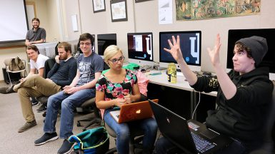 From left, lecturer Will Emigh and students Max Couch, Matt Higham, Adam Christie and Andrea Reinhart listened to junior Angela Lograsso talk about projects. Students in a three-semester workshop develop and publish video games. (Jill Moore | The Media School) 