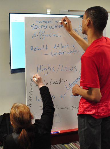 Teams used white boards to brainstorm, them map their games' strategies. (Michael Williams | The Media School)