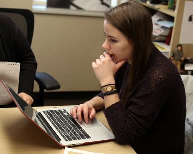 Freshman Lydia Gerike stares at a computer screen.