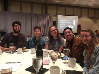 (Left to right) Graduate student Rick Brewer; senior Pealer Bryniarski; senior Abbie Gipson; Angelo Bautista, BA'18; and senior Emily Miles enjoy breakfast before a day of breakout sessions and networking at the third Coast International Audio Festival in Chicago.
