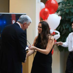 Dean Jim Shanahan recognizes Amber Phillips with a handshake and a small gift.