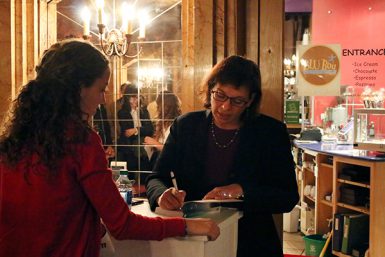 Nazario signed copies of her book, Enrique's Journey, after the talk. The book has been used in high school and college classes, and in book clubs to open discussions about immigration. (Grayson Harbour | The Media School)