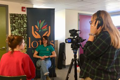 Students Emma Hamilton (left) and Karli VanCleave interview Lotus volunteer and Media School alumna Grace Waltz, BA’16, for a volunteer tribute video as part of The Media School’s Stories of Peace service project.