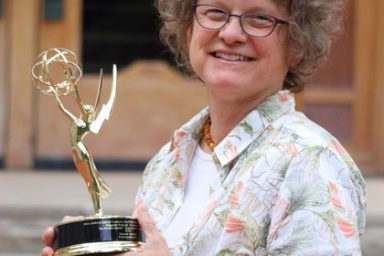 Senior Lecturer Susanne Schwibs holding her regional Emmy