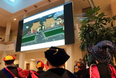 Attendees watch a demo of the game "Tori."