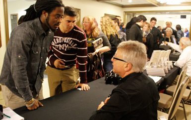 Uslan signing books