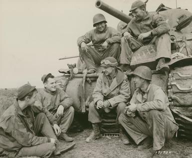 This photo distributed by the U.S. Signal Corps shows Pyle, center, talking with soldiers near Anzio. (National Archives)