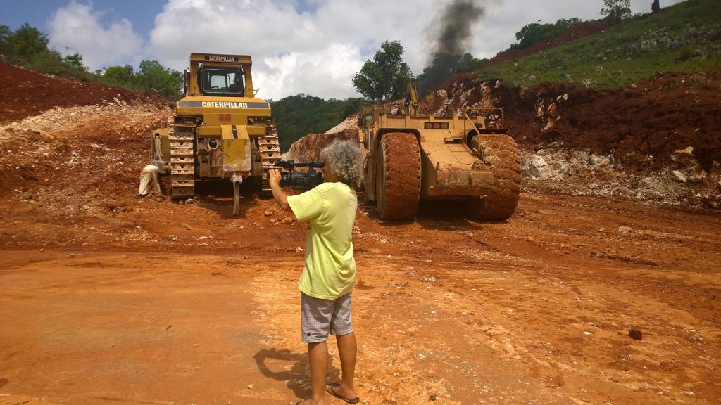 Esther Figueroa shooting video of bauxite mining trucks in Jamaica